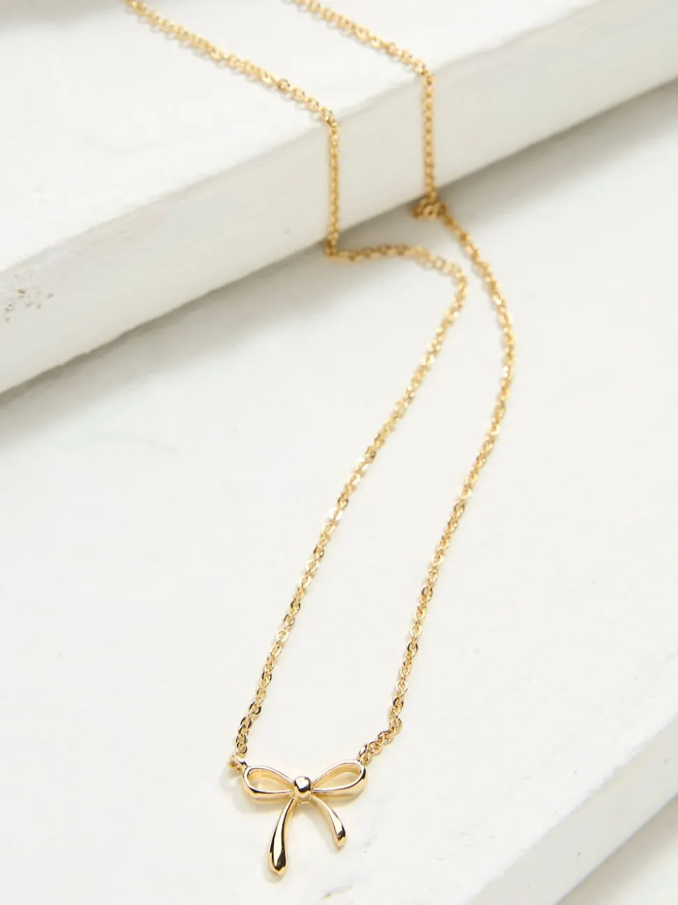 FatFace Gold Tone Bow Pendant Necklace